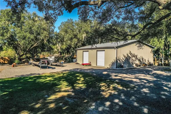 a kitchen with stainless steel appliances granite countertop a refrigerator a sink a stove a microwave and island