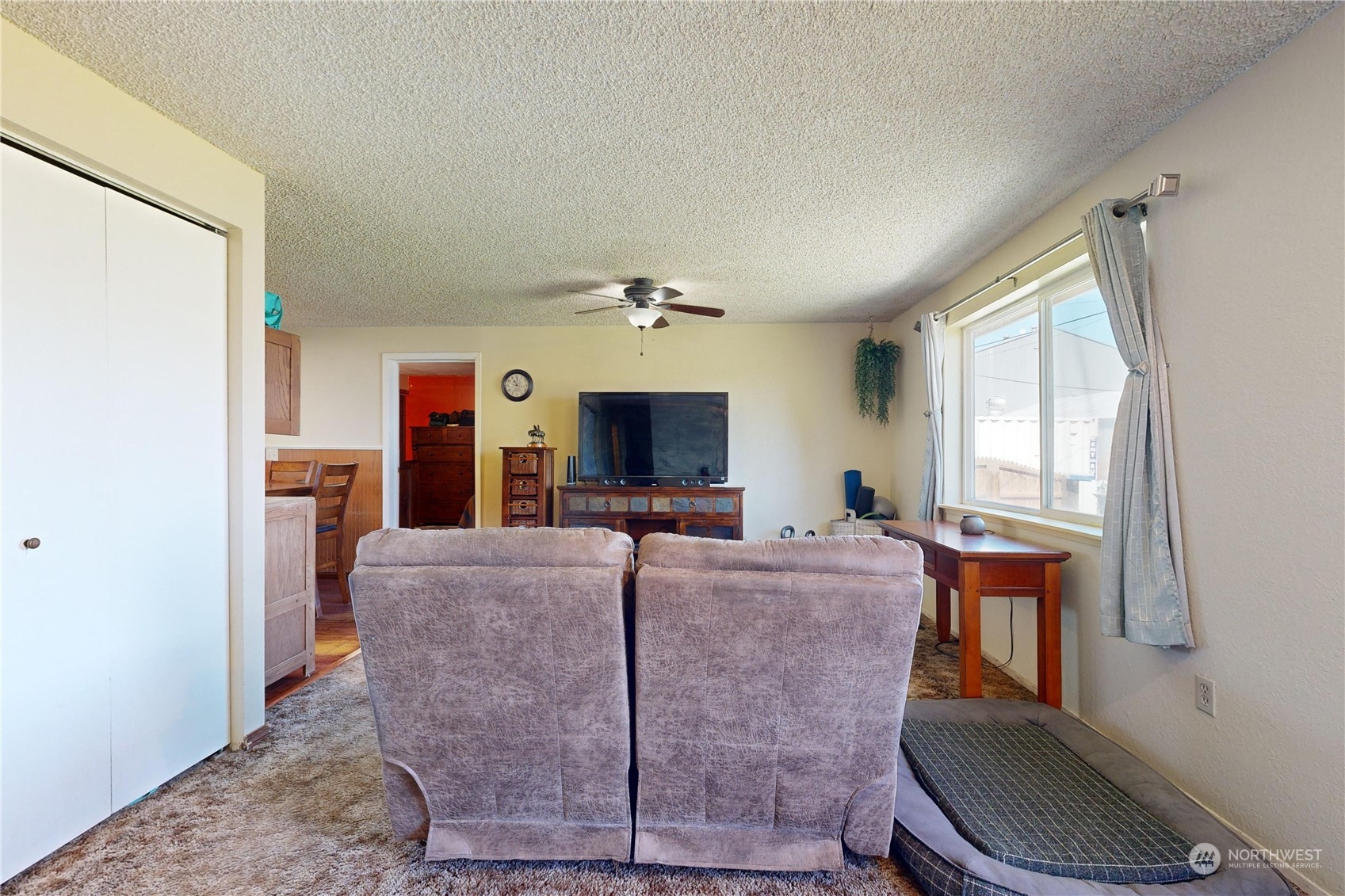 289 Main Street Touchet, WA 99360 - Photo 2 of 40 a living room with furniture a large window and a flat screen tv
