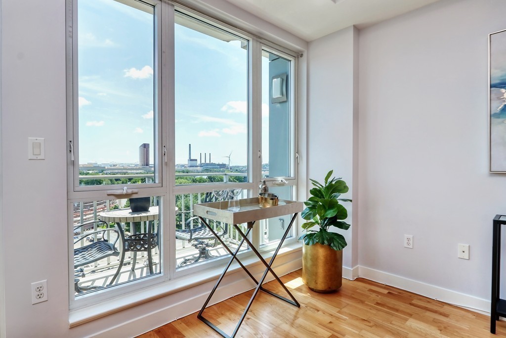 100 Station Landing, Unit 906 Medford, MA 02155 - Photo 11 of 28 a view of a dining room with furniture window and wooden floor