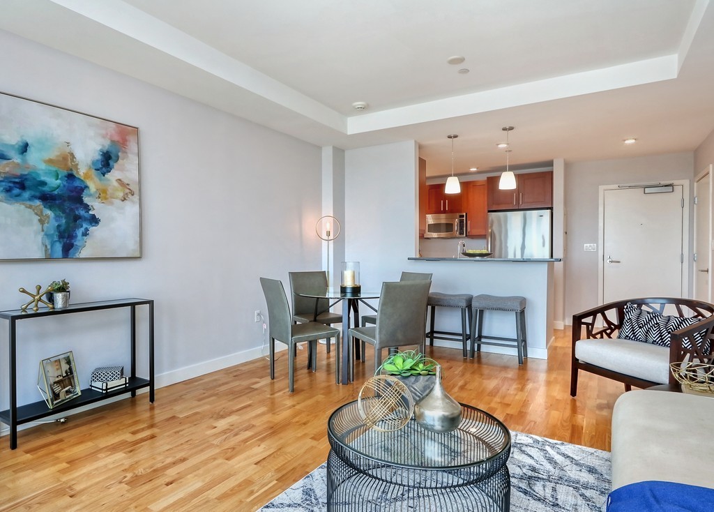 100 Station Landing, Unit 906 Medford, MA 02155 - Photo 12 of 28 a living room with furniture and a fireplace