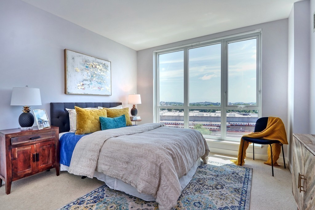 100 Station Landing, Unit 906 Medford, MA 02155 - Photo 13 of 28 a bed room with a bed and a chair