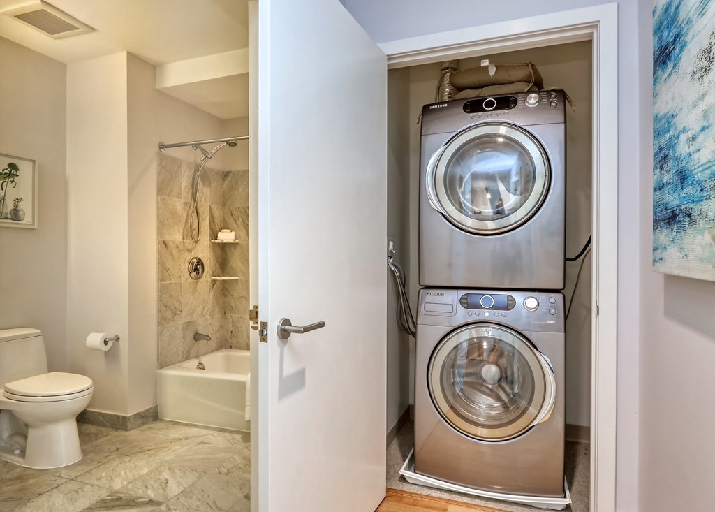 100 Station Landing, Unit 906 Medford, MA 02155 - Photo 15 of 28 a view of a bathroom with a washer and dryer