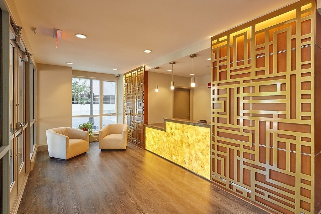 100 Station Landing, Unit 906 Medford, MA 02155 - Photo 19 of 28 a living room with furniture and wooden floor