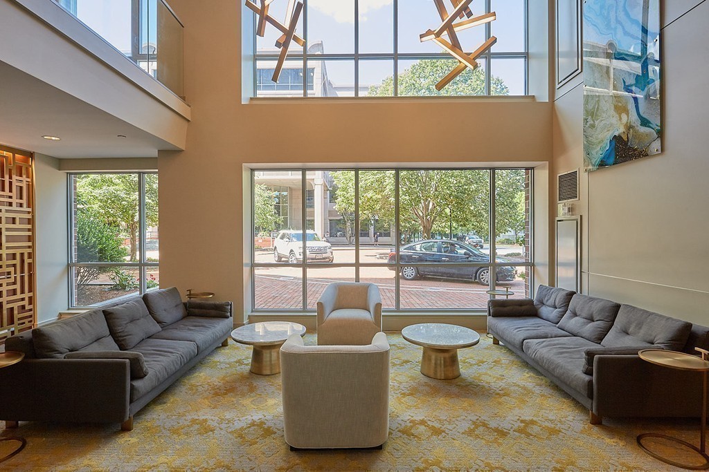 100 Station Landing, Unit 906 Medford, MA 02155 - Photo 20 of 28 a living room with furniture and a large window