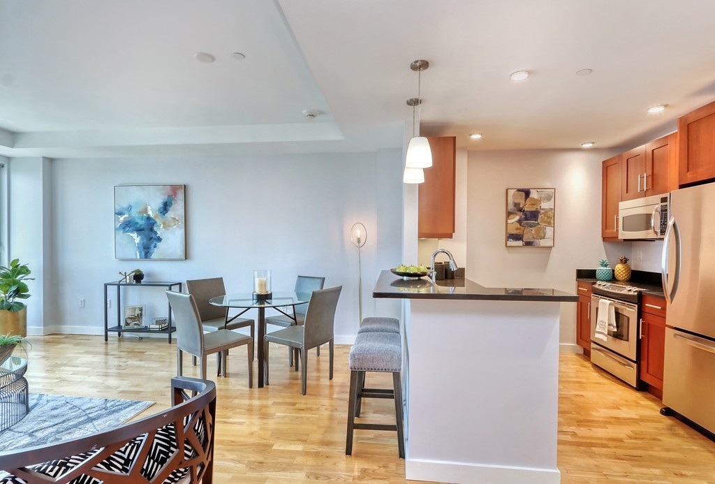 100 Station Landing, Unit 906 Medford, MA 02155 - Photo 2 of 28 a view of a kitchen and dining room