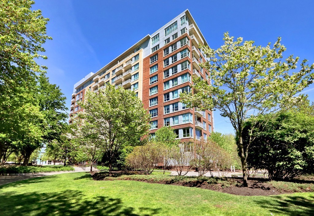 100 Station Landing, Unit 906 Medford, MA 02155 - Photo 27 of 28 a view of a large building with a big yard and large trees