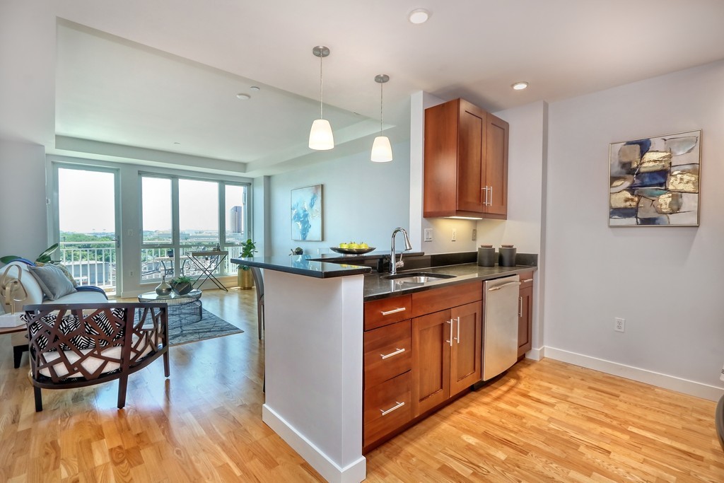 100 Station Landing, Unit 906 Medford, MA 02155 - Photo 3 of 28 a very nice looking living room with a large window and dining table