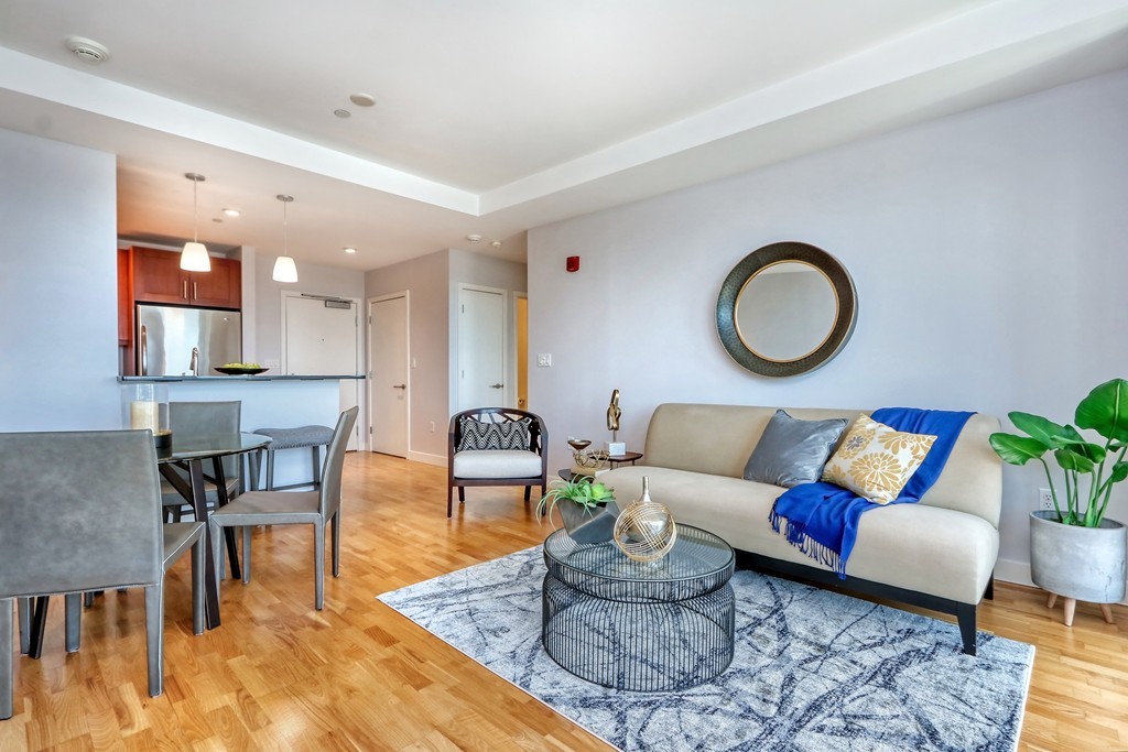 100 Station Landing, Unit 906 Medford, MA 02155 - Photo 7 of 28 a living room with furniture and wooden floor