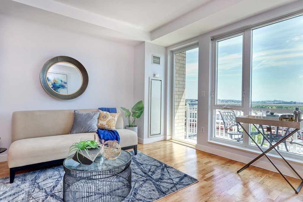 100 Station Landing, Unit 906 Medford, MA 02155 - Photo 8 of 28 a living room with furniture and floor to ceiling windows