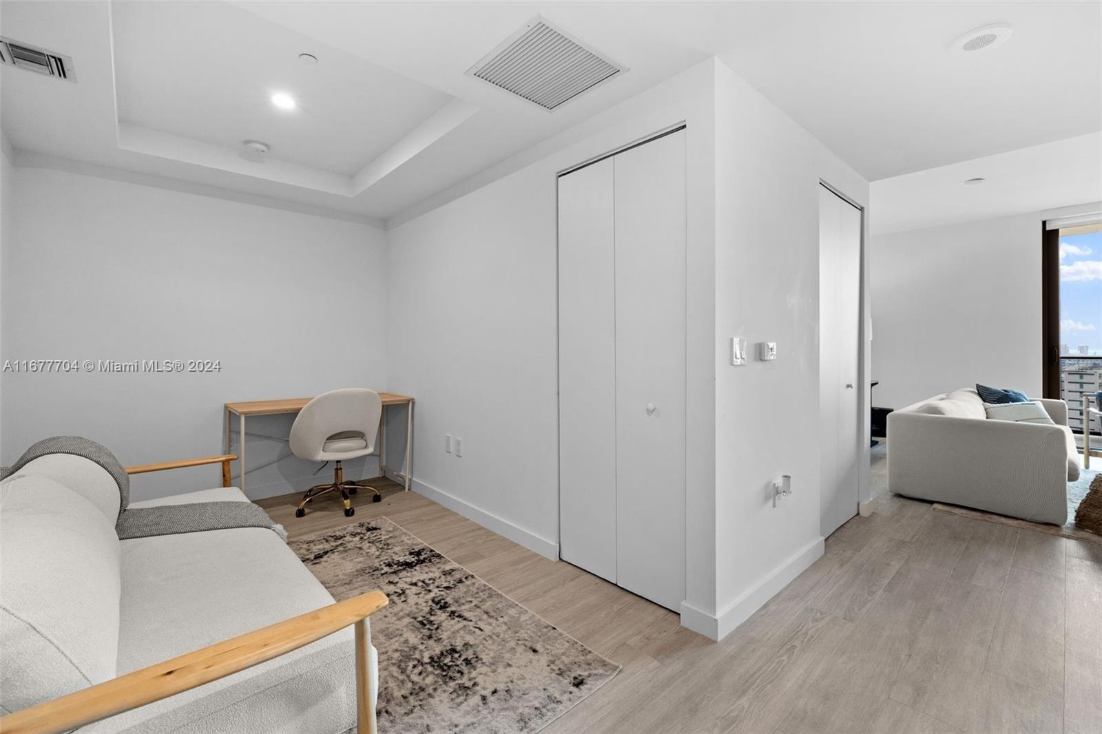 45 Southwest 9th Street, Unit 3802 Miami, FL 33130 - Photo 13 of 40 a living room with furniture and a flat screen tv