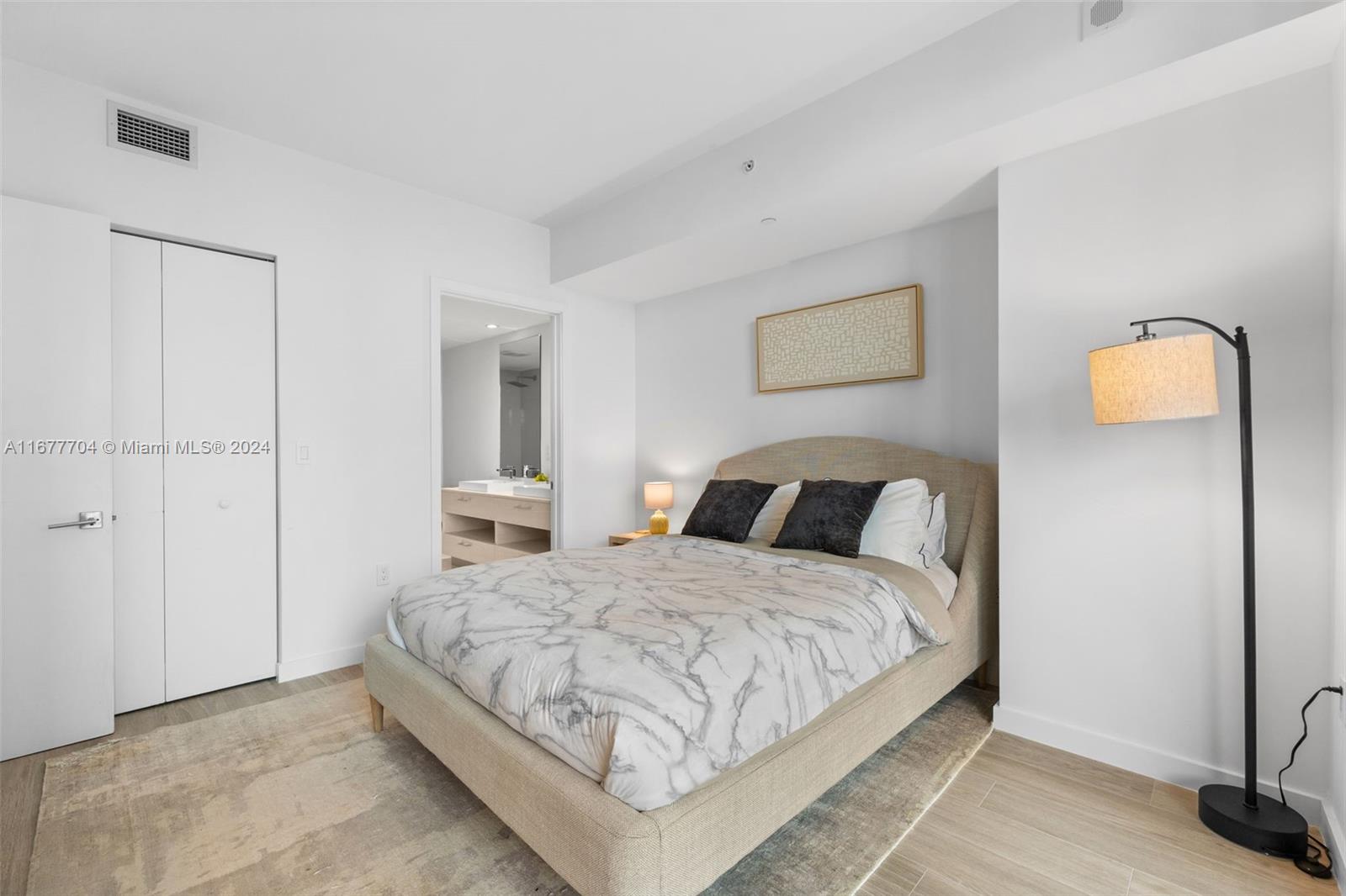 45 Southwest 9th Street, Unit 3802 Miami, FL 33130 - Photo 3 of 40 a bedroom with a bed and a lamp