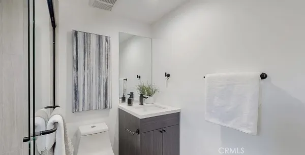a bedroom with furniture and a mirror
