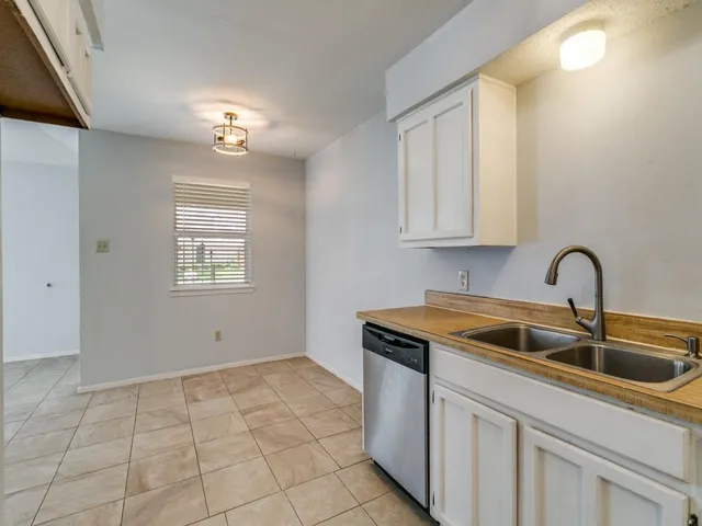 a kitchen that has a sink and cabinets