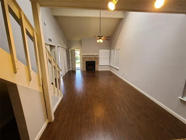 wooden floor in an empty room with a fireplace