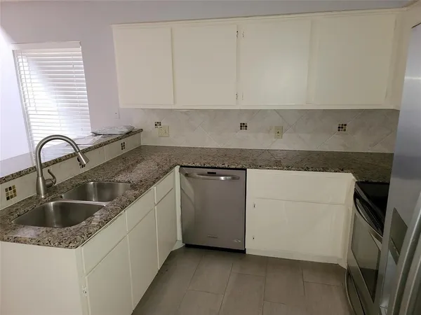 a close view of a sink and dishwasher in a kitchen