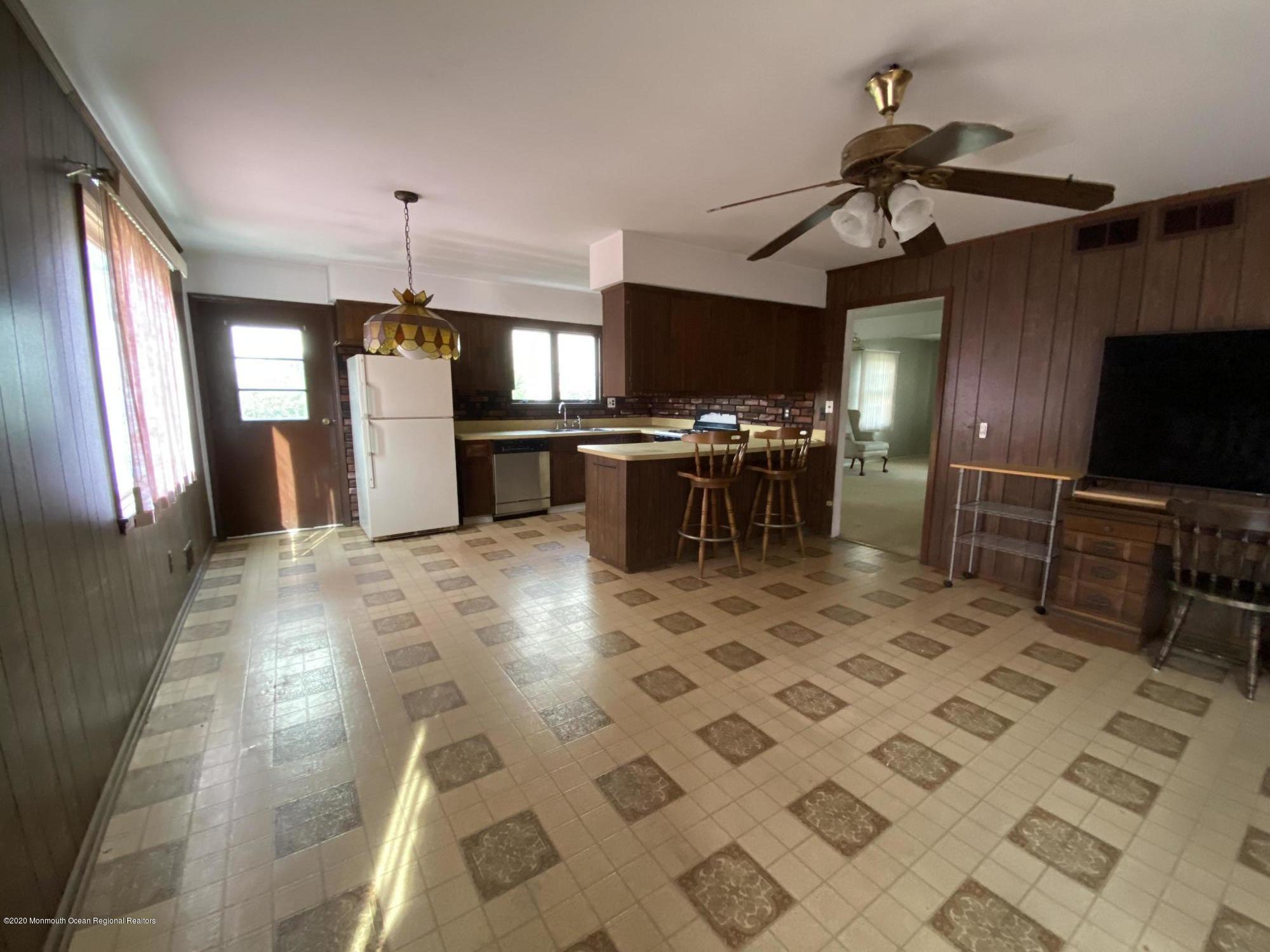 717 Ocean Road Spring Lake Heights, NJ 07762 - Photo 8 of 24 a view of a kitchen with kitchen island a window a sink and a counter top space