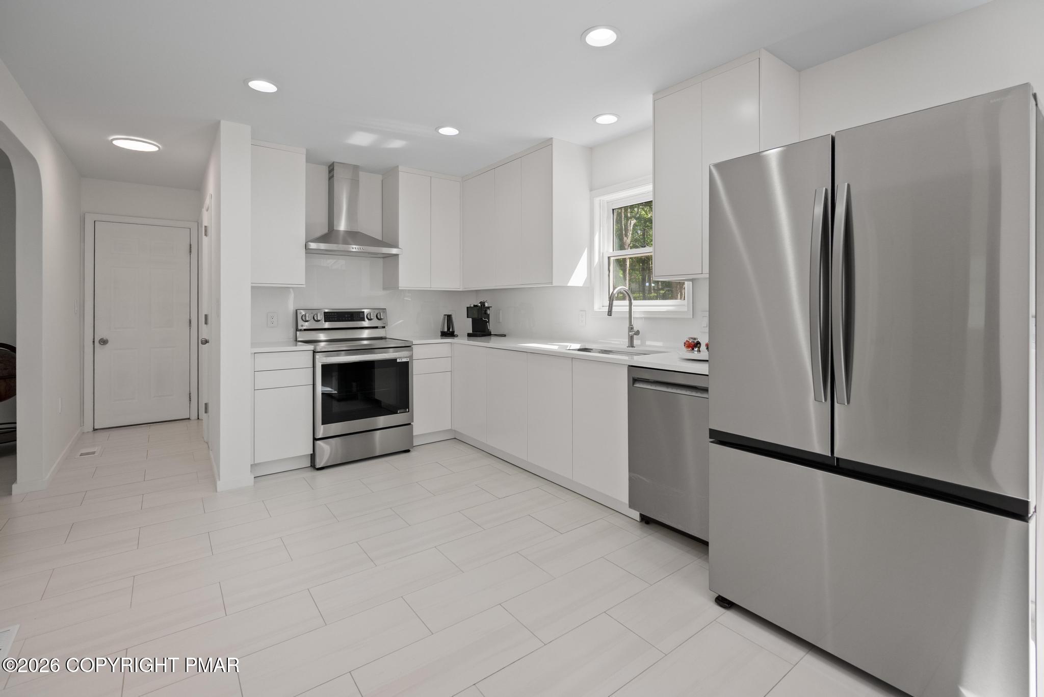 2312 Cramer Court Bushkill, PA 18324 - Photo 10 of 37 a kitchen with white cabinets and stainless steel appliances