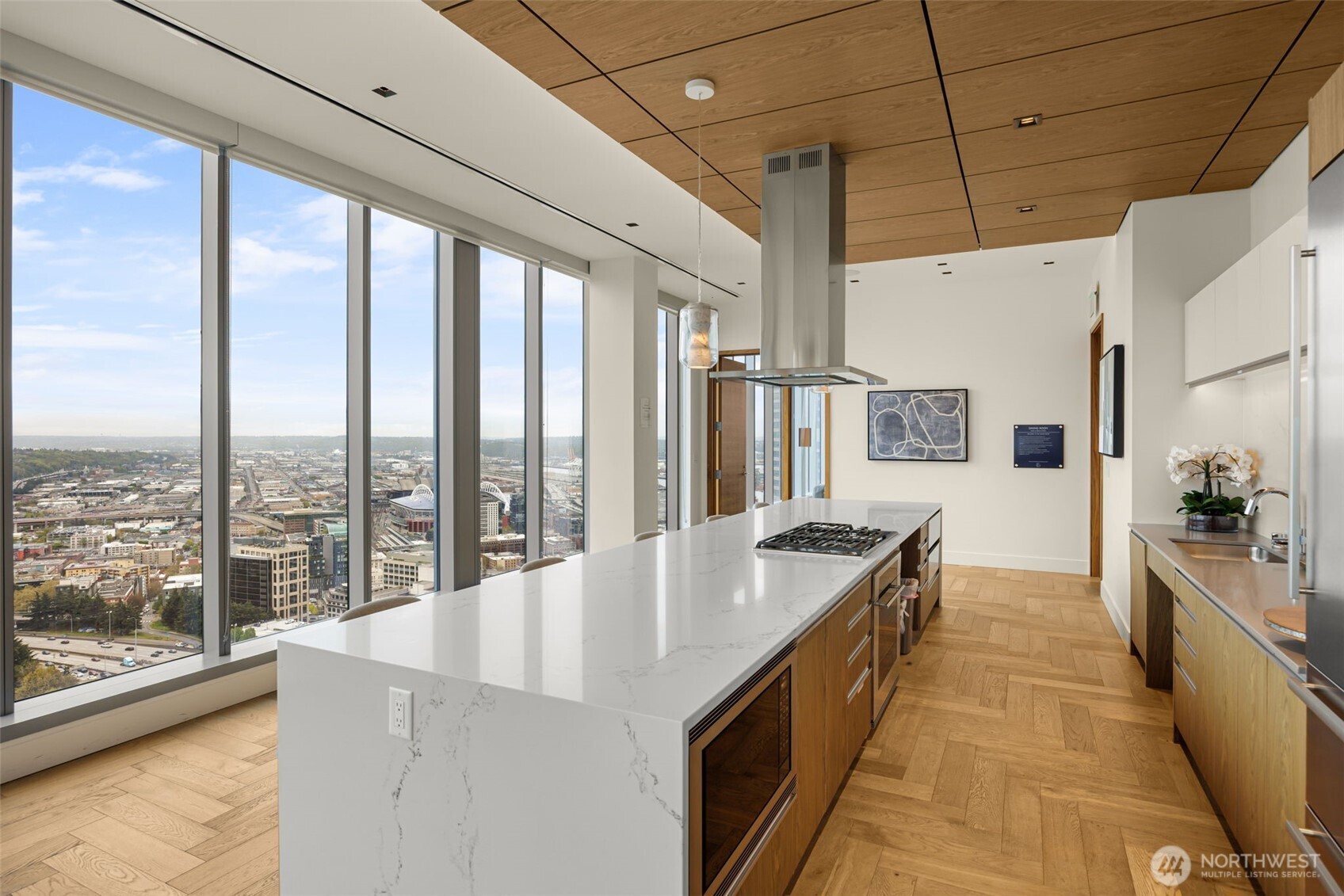 800 Columbia Street, Unit 808 Seattle, WA 98104 - Photo 11 of 38 a large kitchen with kitchen island a large window a sink and stainless steel appliances
