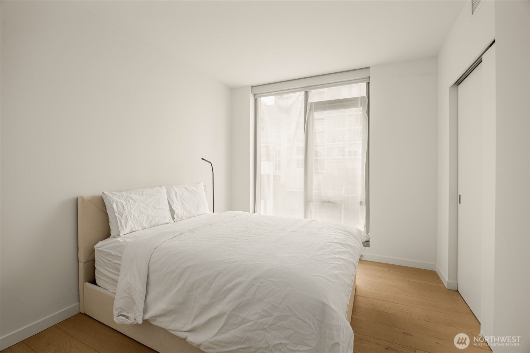 800 Columbia Street, Unit 808 Seattle, WA 98104 - Photo 17 of 38 a large bed in a bedroom next to a window