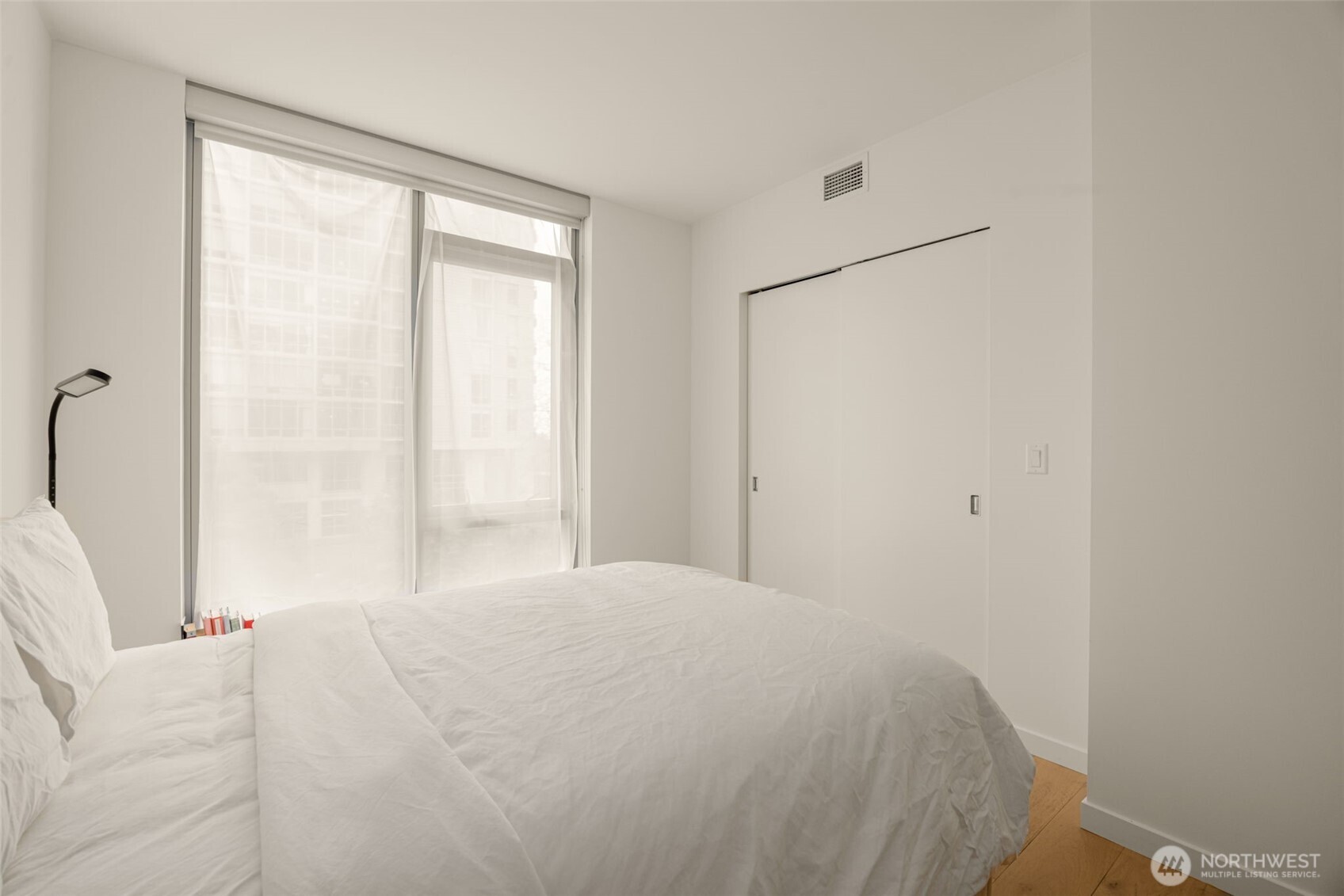 800 Columbia Street, Unit 808 Seattle, WA 98104 - Photo 18 of 38 a bedroom with a bed and a large window