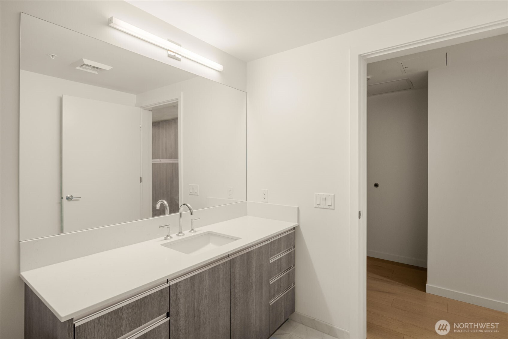 800 Columbia Street, Unit 808 Seattle, WA 98104 - Photo 21 of 38 a bathroom with a sink and a mirror