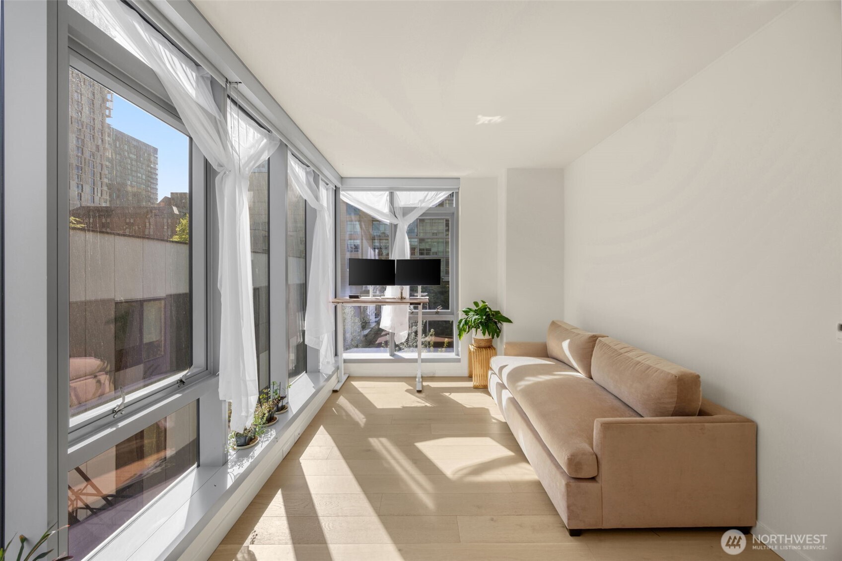 800 Columbia Street, Unit 808 Seattle, WA 98104 - Photo 31 of 38 a living room with furniture and a floor to ceiling window