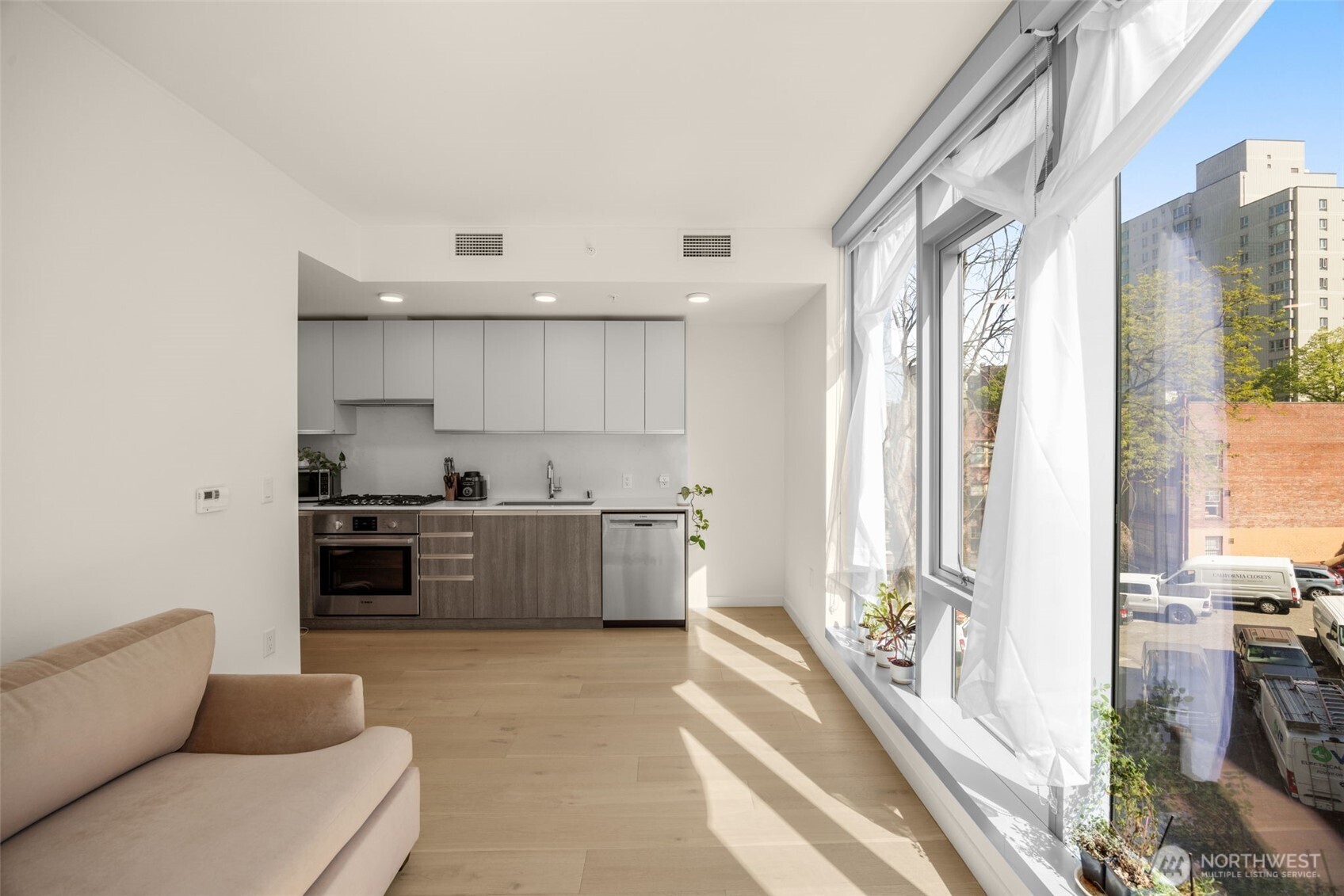 800 Columbia Street, Unit 808 Seattle, WA 98104 - Photo 32 of 38 a large white kitchen with a large window