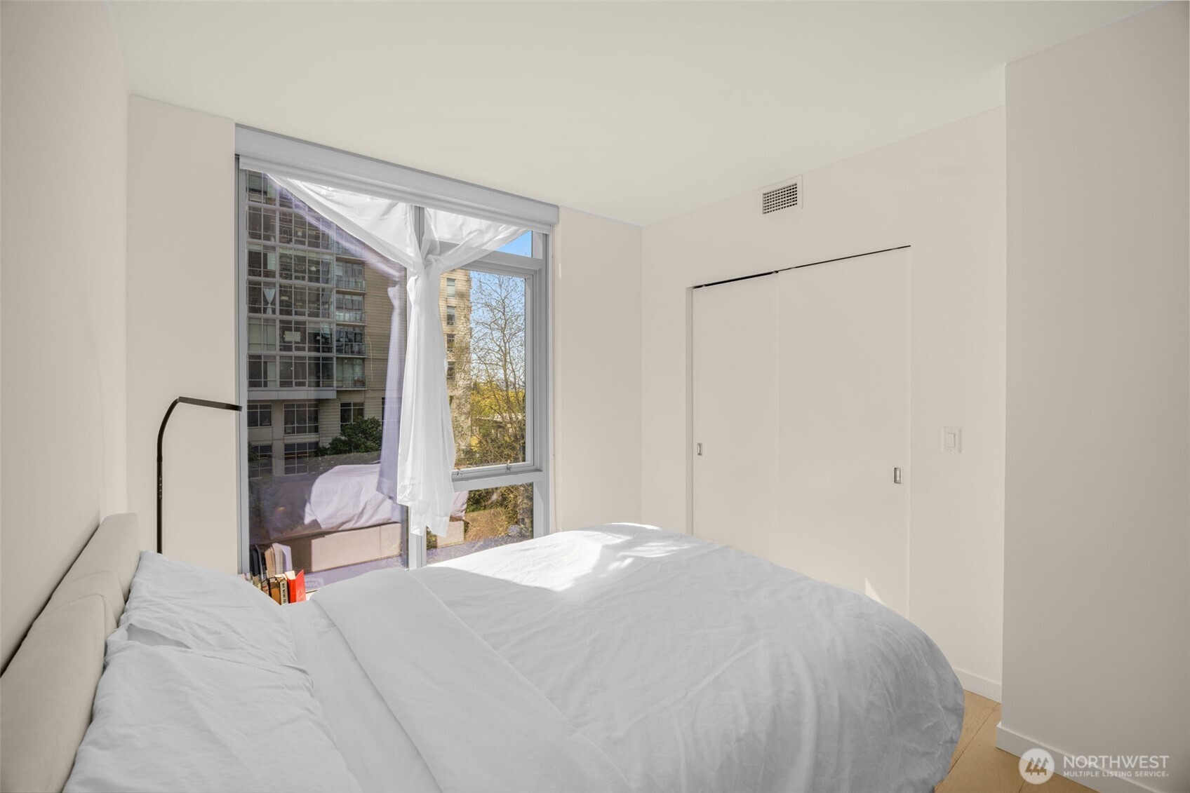 800 Columbia Street, Unit 808 Seattle, WA 98104 - Photo 34 of 38 a bedroom with a bed and a window