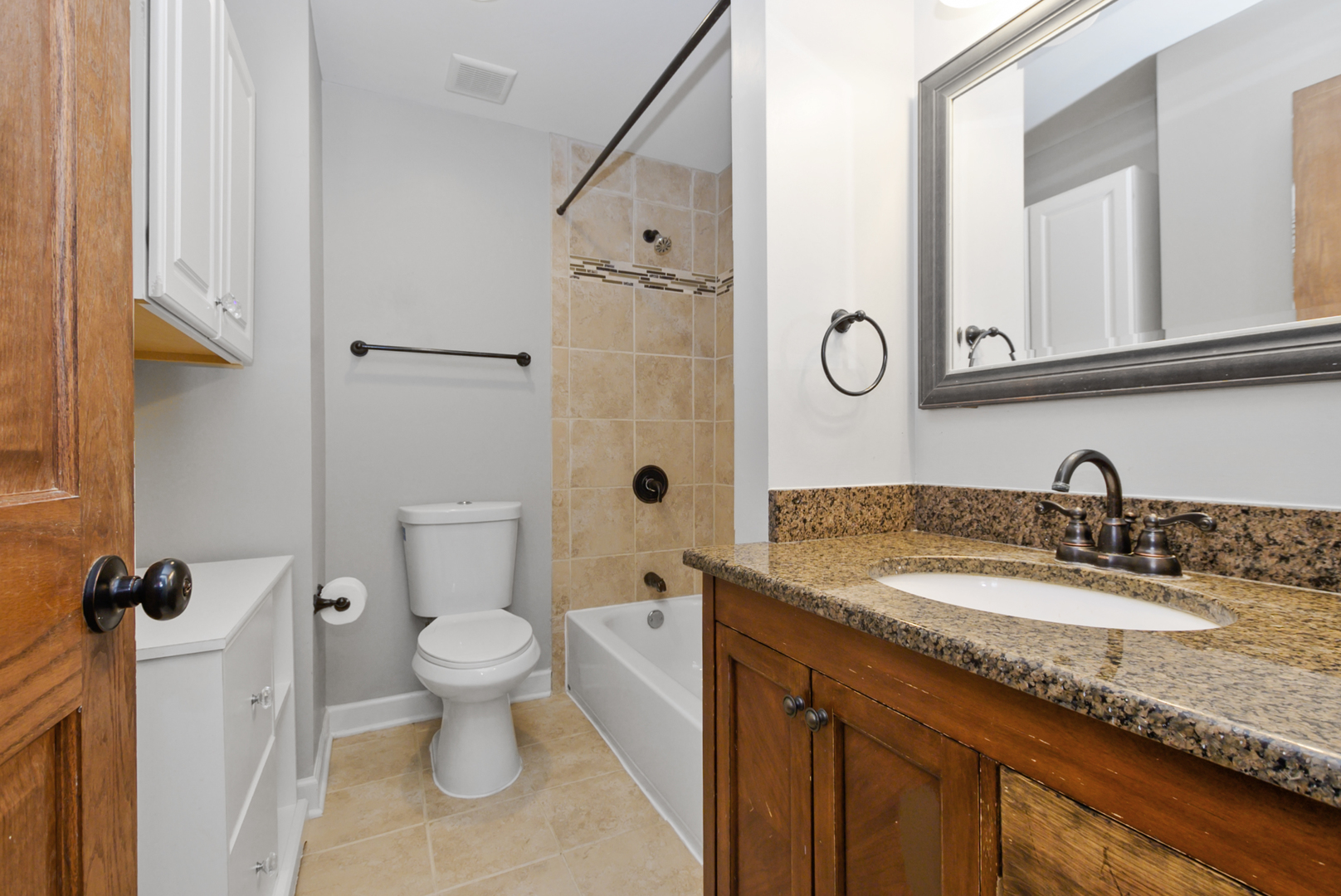 433 Hackberry Road Frankfort, IL 60423 - Photo 16 of 27 a bathroom with a granite countertop sink a toilet and a mirror