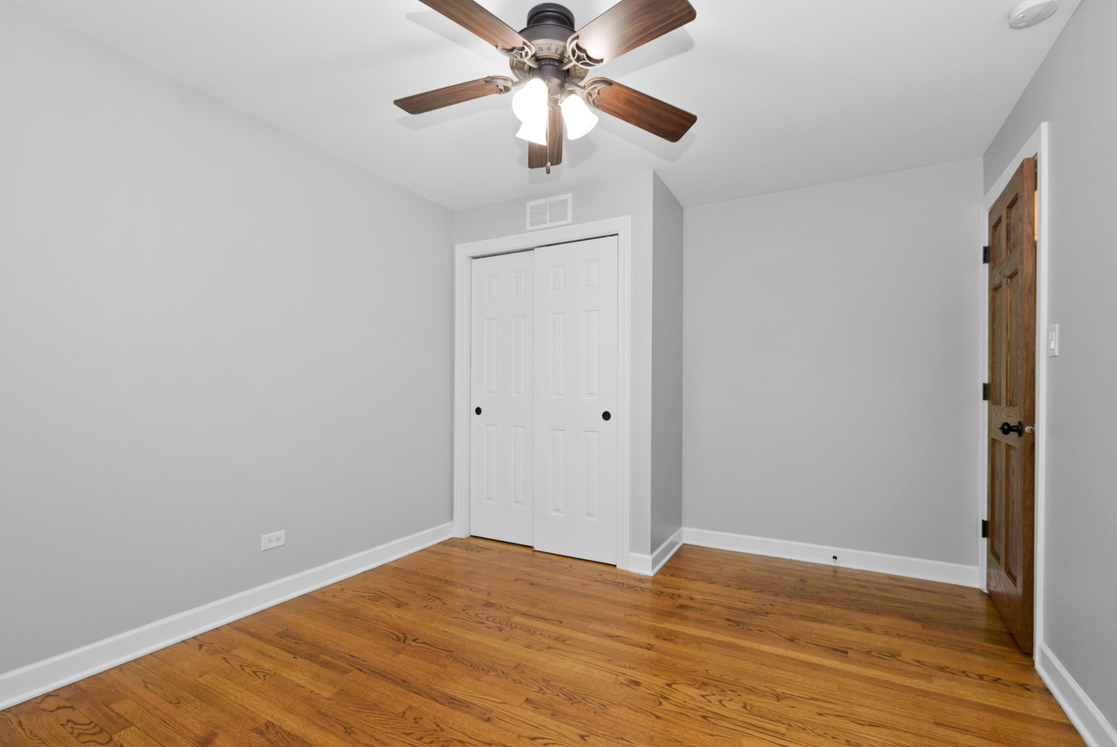 433 Hackberry Road Frankfort, IL 60423 - Photo 18 of 27 a view of a room with wooden floor and a ceiling fan