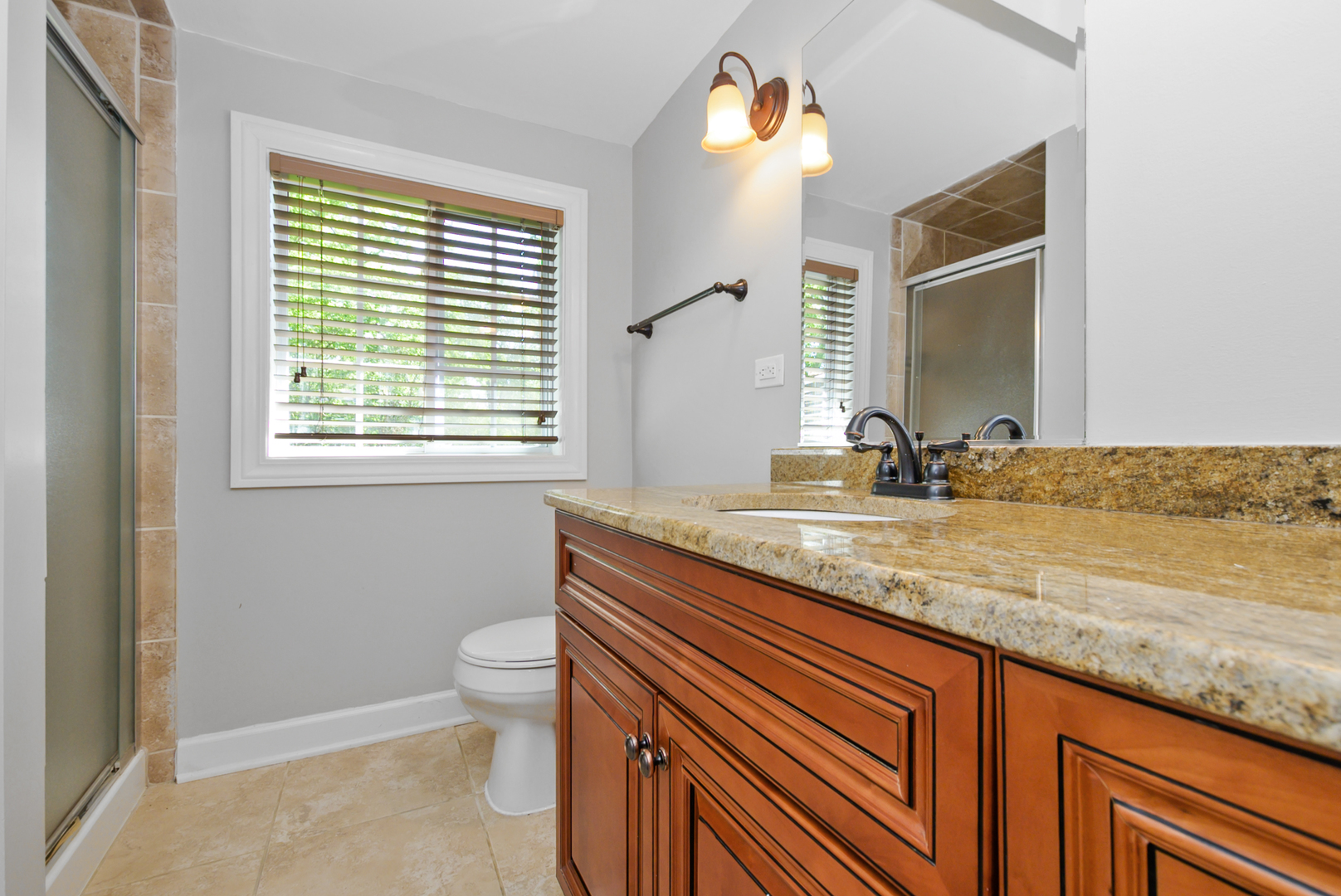 433 Hackberry Road Frankfort, IL 60423 - Photo 19 of 27 a bathroom with a granite countertop sink a toilet and a mirror