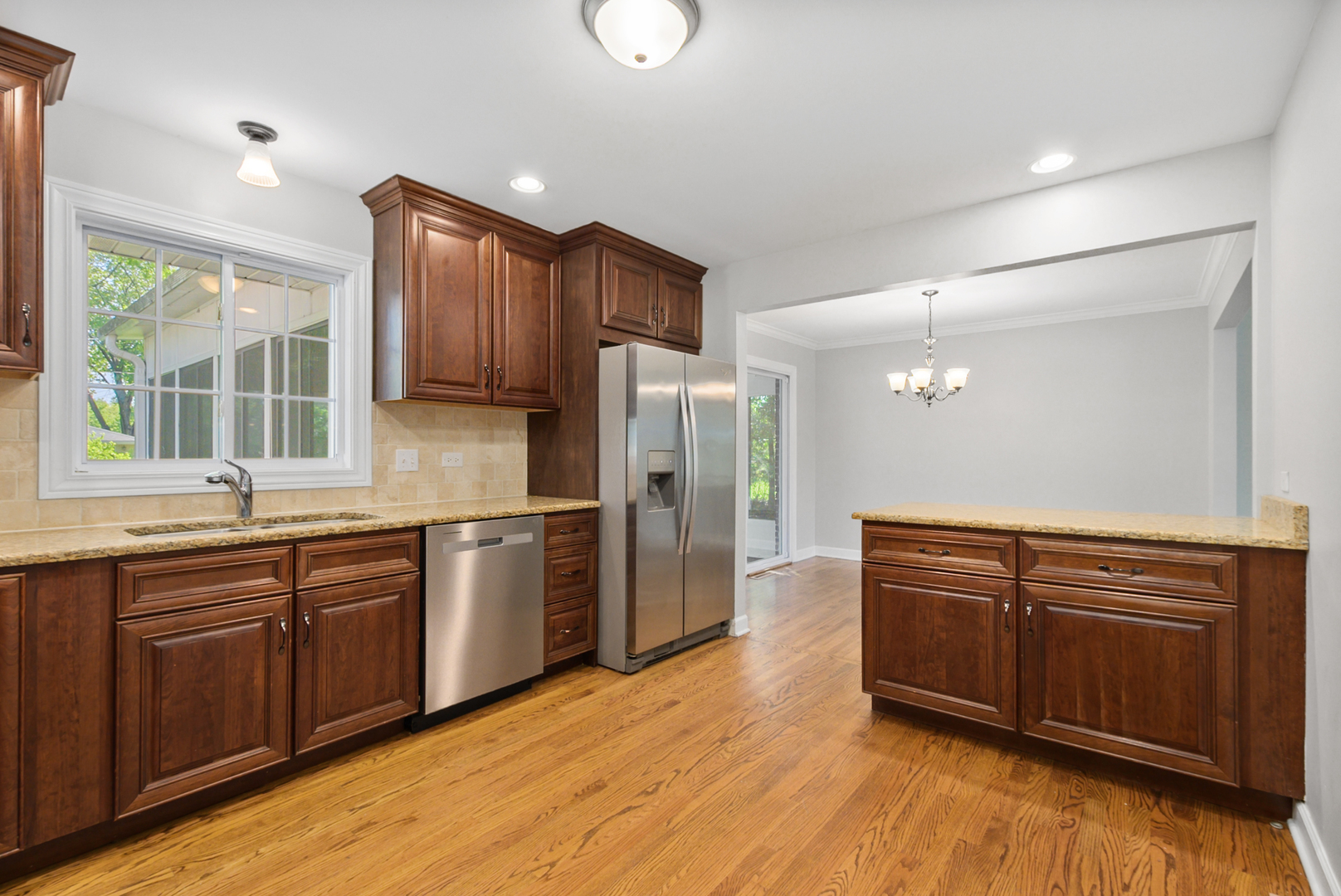 433 Hackberry Road Frankfort, IL 60423 - Photo 4 of 27 a kitchen with stainless steel appliances granite countertop a sink a stove a refrigerator and cabinets
