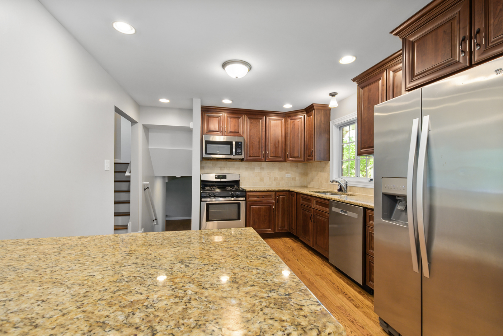 433 Hackberry Road Frankfort, IL 60423 - Photo 5 of 27 a kitchen with stainless steel appliances granite countertop a refrigerator and a stove top oven
