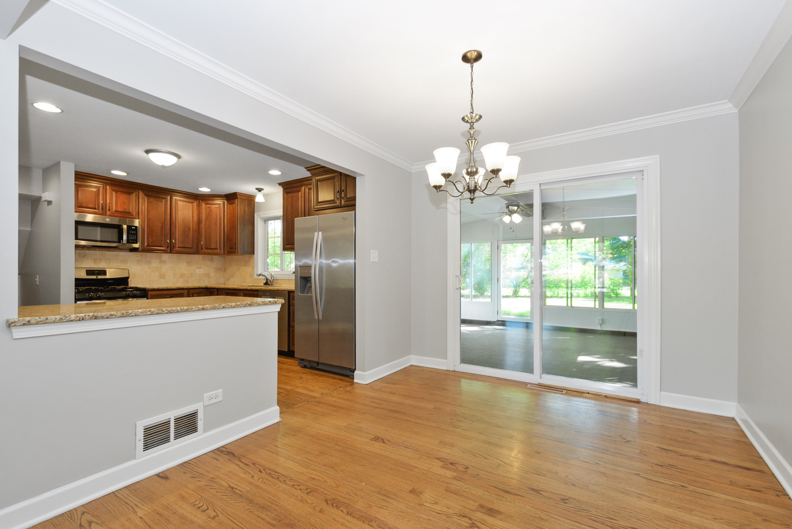 433 Hackberry Road Frankfort, IL 60423 - Photo 7 of 27 a open kitchen with stainless steel appliances granite countertop a refrigerator oven a sink dishwasher and a stove with wooden floor