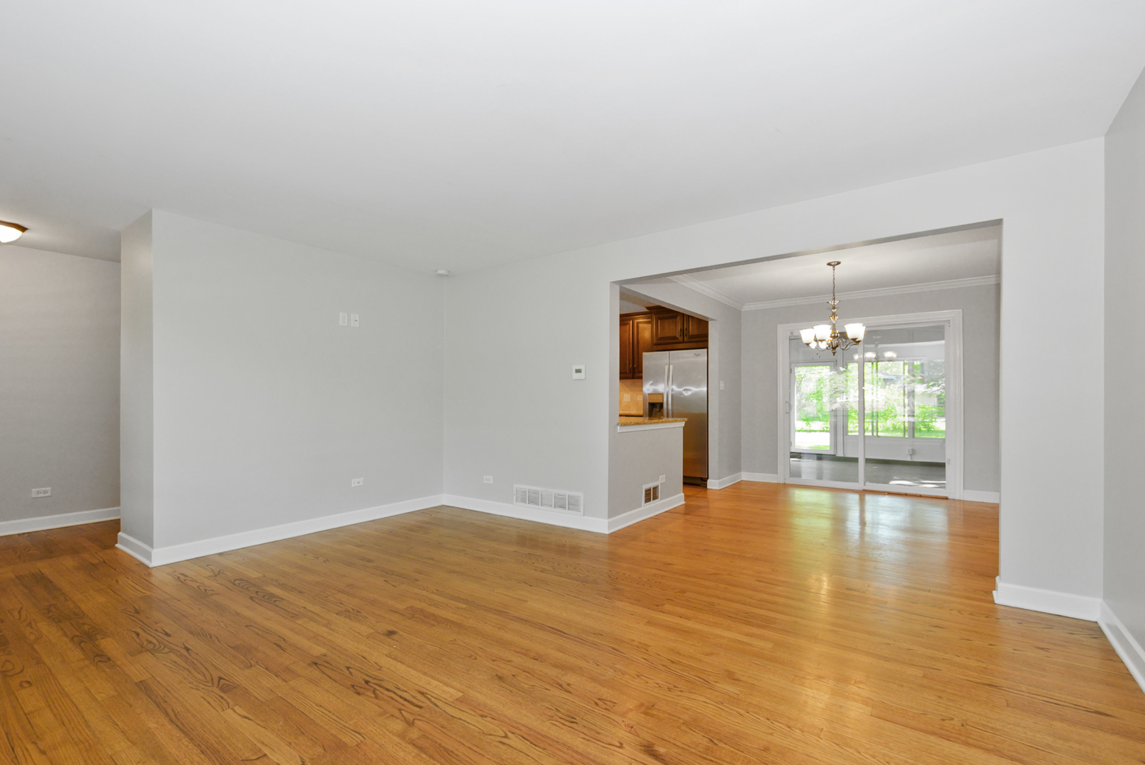 433 Hackberry Road Frankfort, IL 60423 - Photo 8 of 27 a view of empty room with wooden floor and fan