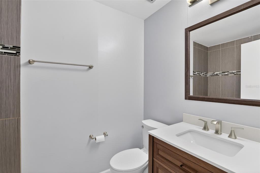 2340 Merrily Circle South Seffner, FL 33584 - Photo 30 of 52 a bathroom with a sink toilet and mirror