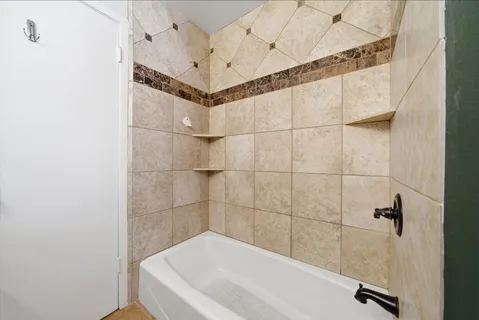 a bathroom with a bathtub and shower