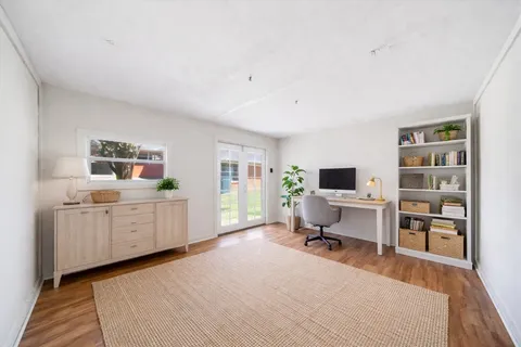 a room with furniture a flat screen tv and a window