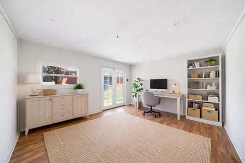 a room with furniture a flat screen tv and a window