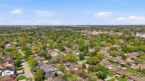 an aerial view of a houses with a yard