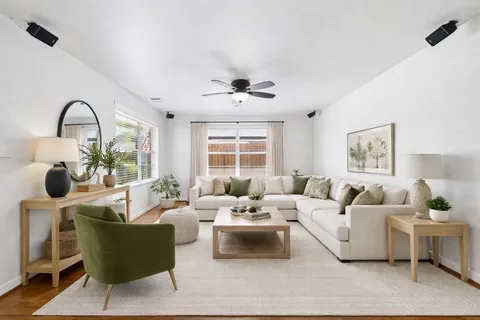 a living room with furniture and a large window