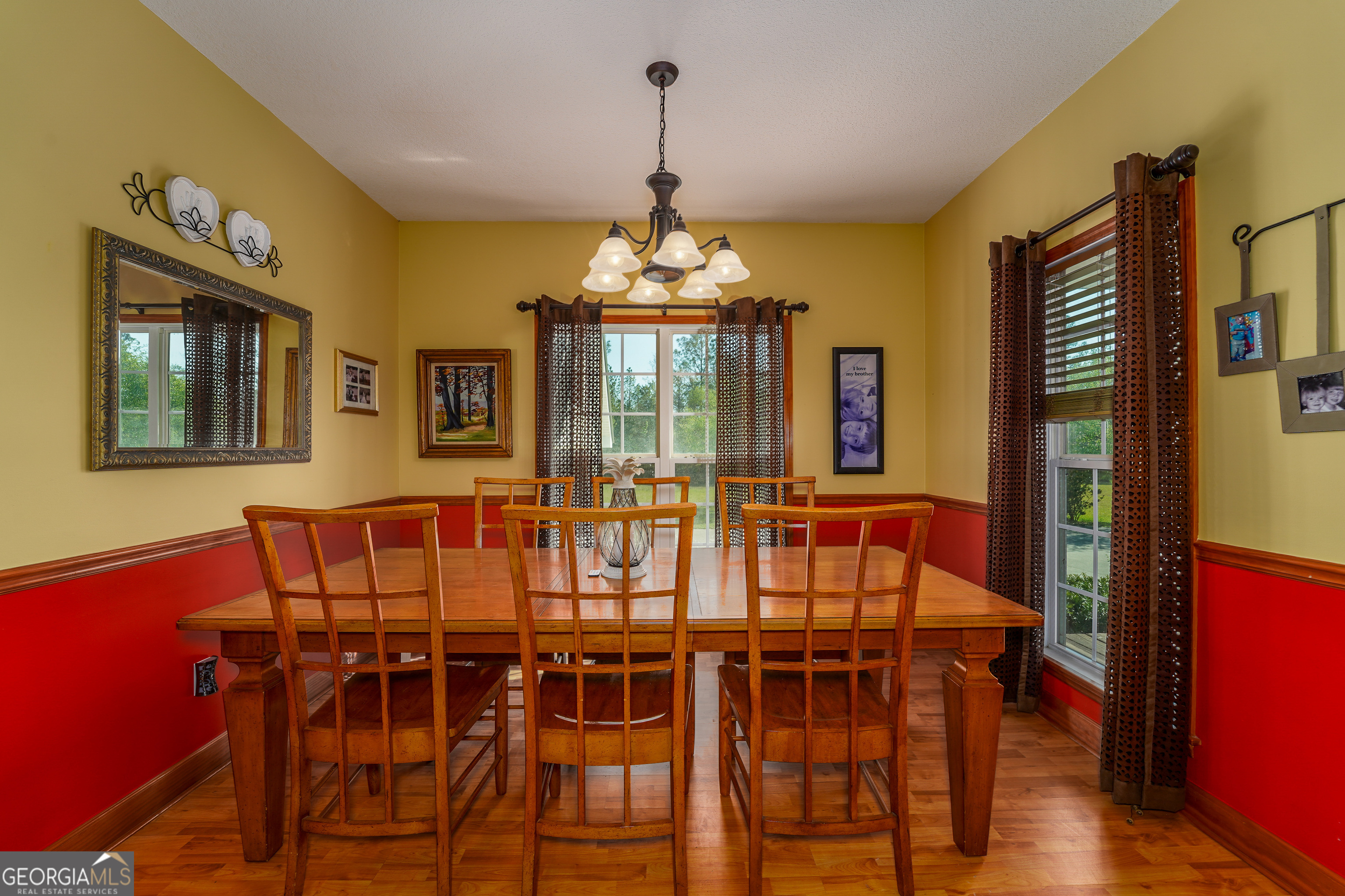 3300 Connor Lane Waycross, GA 31503 - Photo 22 of 42 a view of a dining room with furniture window and wooden floor