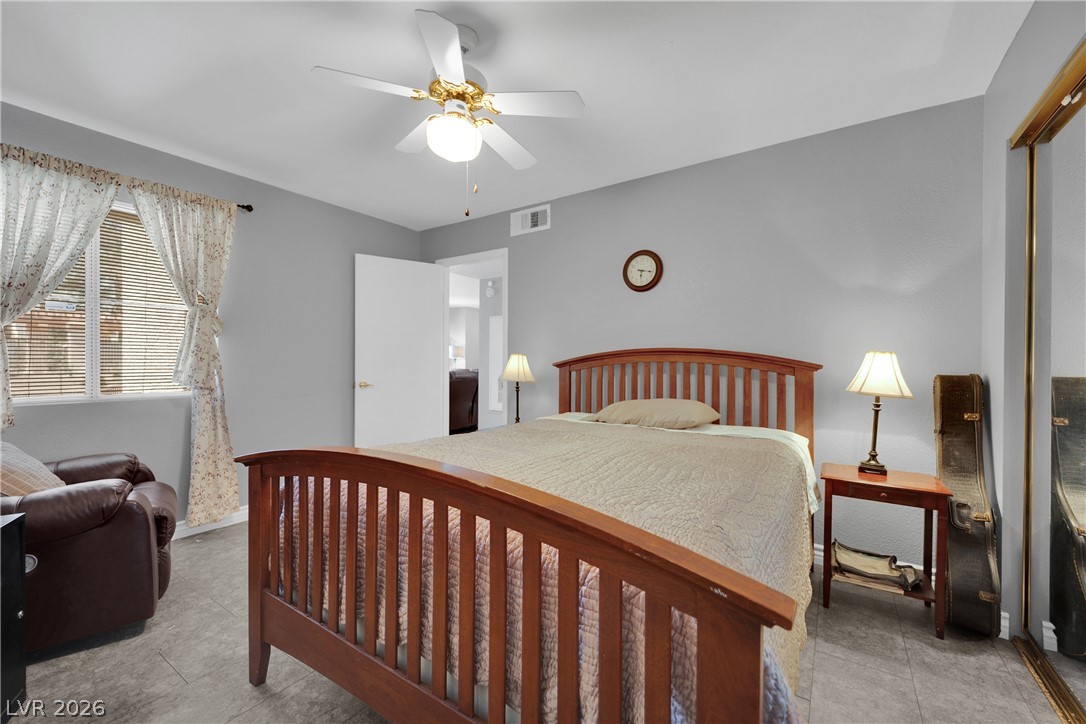 7570 West Flamingo Road, Unit 115 Las Vegas, NV 89147 - Photo 19 of 34 Well-lit sleeping quarters with elegant window treatments and durable flooring.