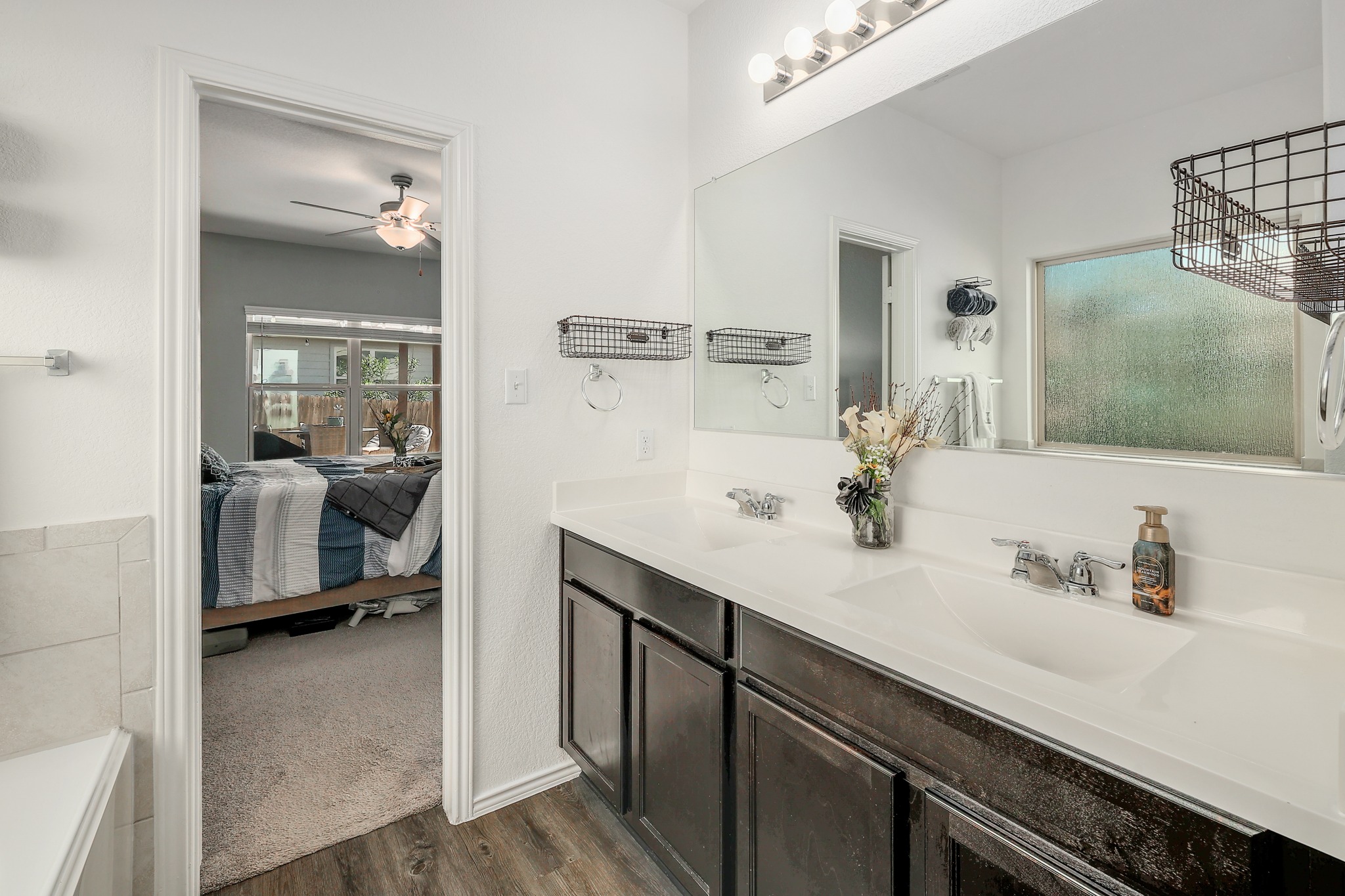 735 Circle Way Jarrell, TX 76537 - Photo 12 of 32 An integrated vanity with dual sinks anchors this modern bathroom connected to the bedroom.