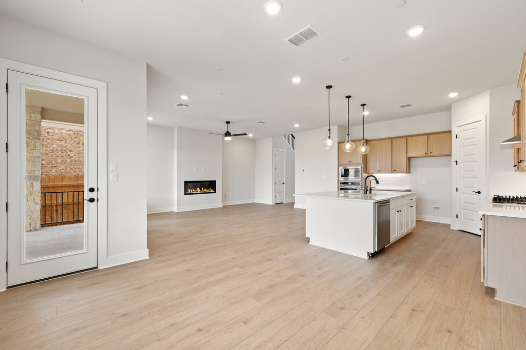 6313 Leftwich Cove Austin, TX 78738 - Photo 37 of 39 a view of kitchen with kitchen island white cabinets and wooden floor