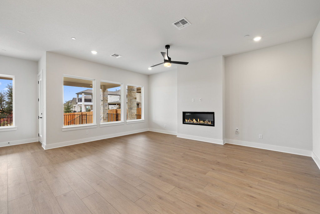 6313 Leftwich Cove Austin, TX 78738 - Photo 13 of 39 a view of an empty room with a window and wooden floor