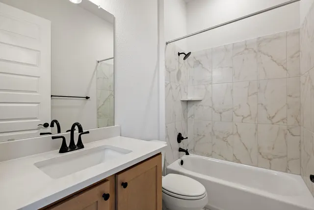 a large kitchen with stainless steel appliances kitchen island a large counter top and a wooden floors