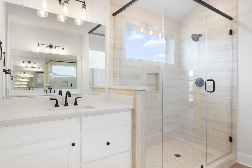 6313 Leftwich Cove Austin, TX 78738 - Photo 23 of 39 a bathroom with a shower sink and mirror