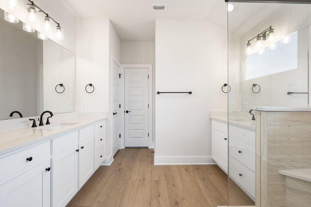 6313 Leftwich Cove Austin, TX 78738 - Photo 24 of 39 a spacious bathroom with a double vanity sink mirror and shower