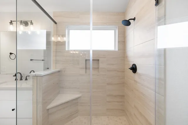 a spacious bathroom with a double vanity sink mirror and shower